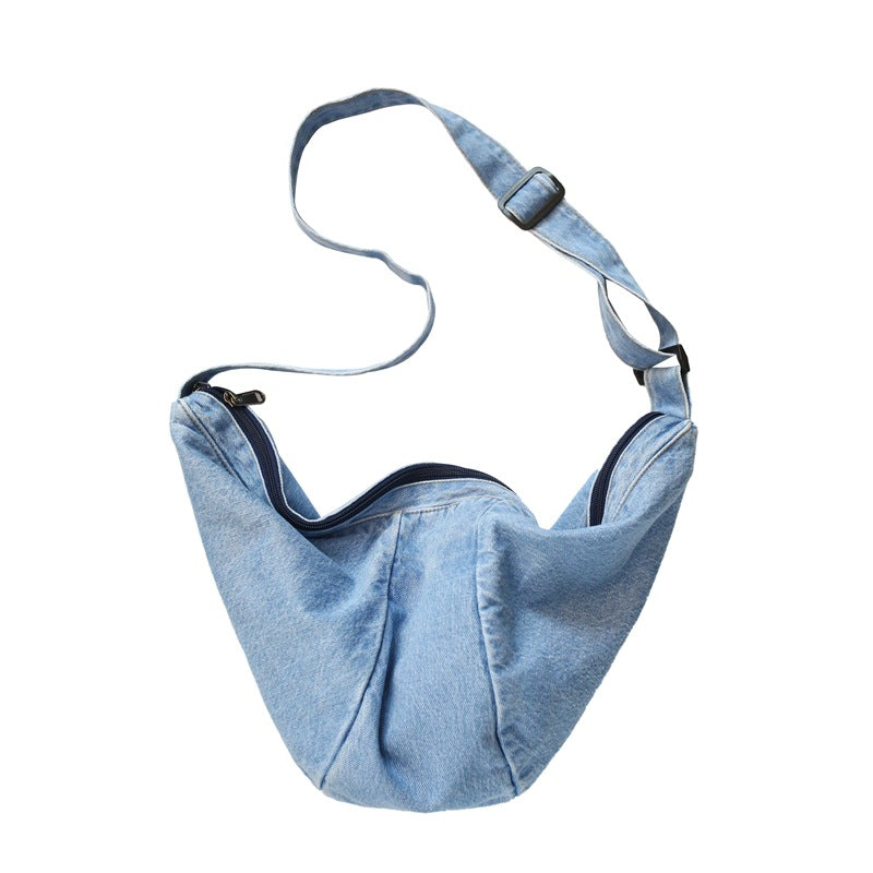 Washed denim crescent bag with adjustable strap and roomy design