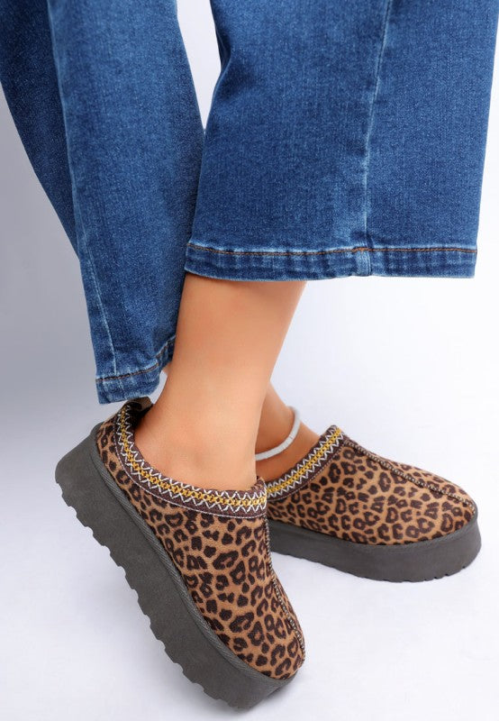 model wearing leopard print platform shoes styled with cropped denim