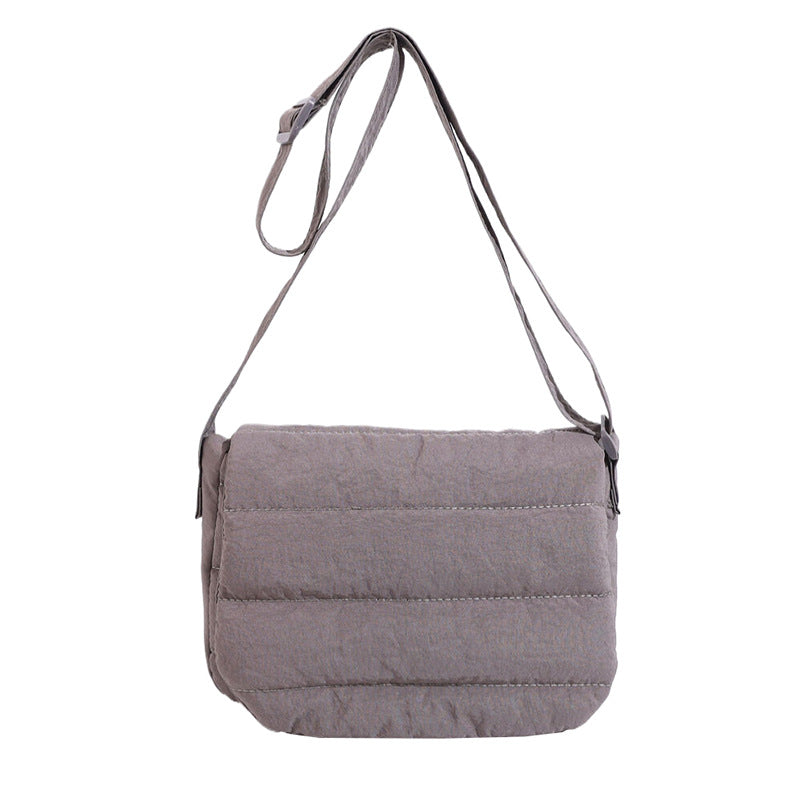 Gray quilted shoulder bag on a white background