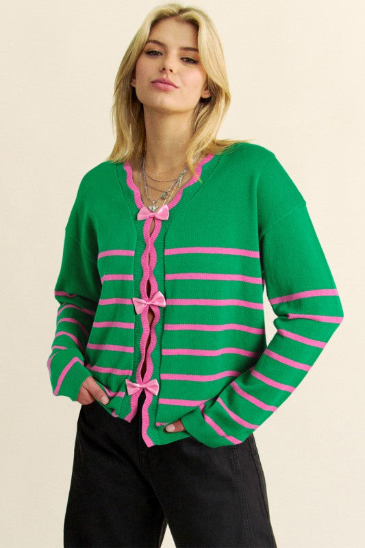 Green and pink striped bow-front cardigan worn on model, front view