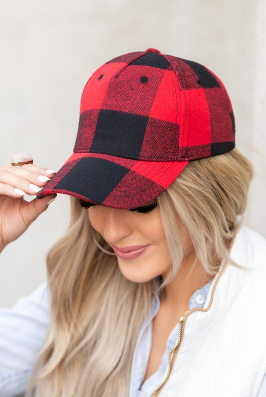 Close-up of red and black buffalo plaid knit flannel baseball hat with curved brim.