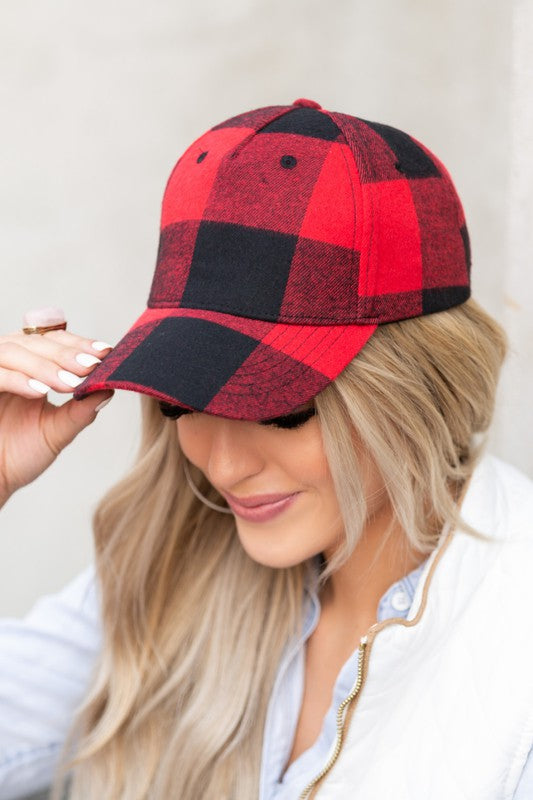 Close-up of red and black buffalo plaid knit flannel baseball hat with curved brim.