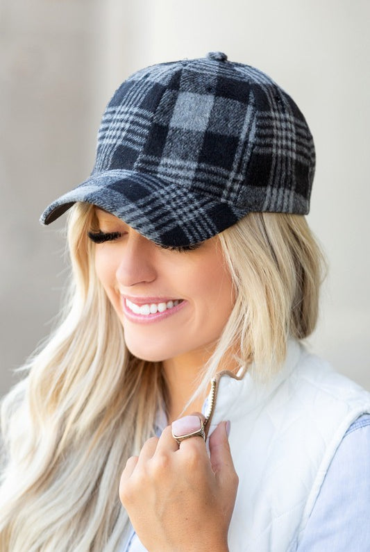 Front angle of black plaid knit flannel baseball hat with curved brim.