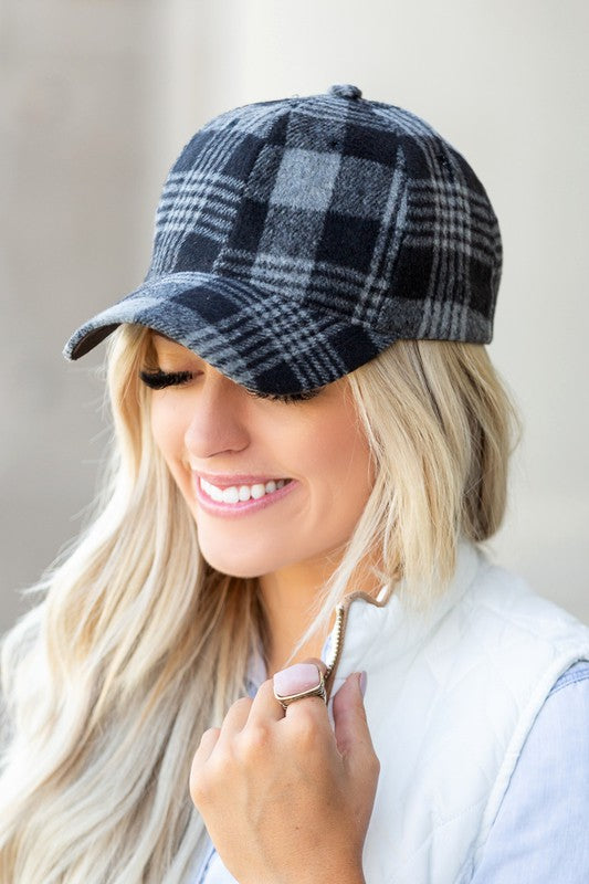 Front angle of black plaid knit flannel baseball hat with curved brim.