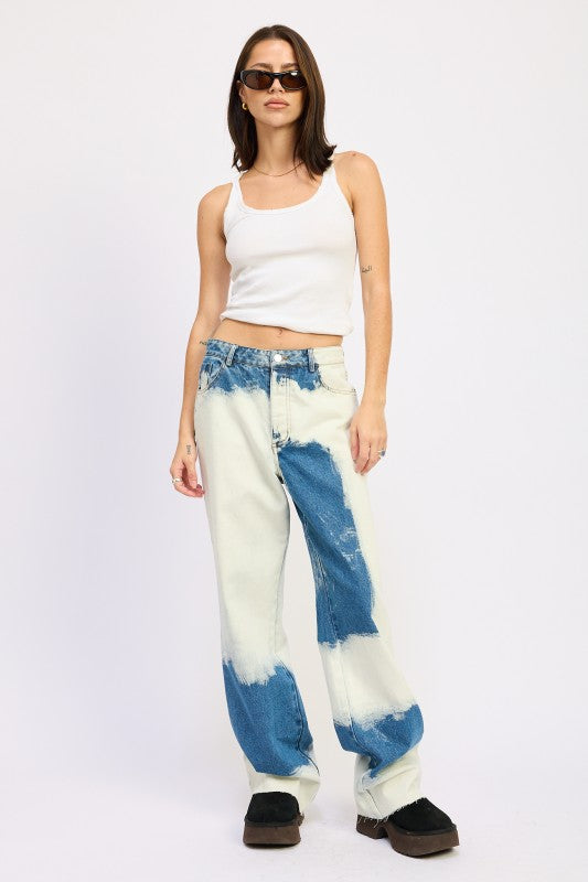 Model wearing AVAH tie-dye effect wide-leg jeans with white tank top, full front view