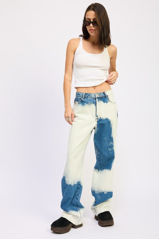 Model wearing AVAH tie-dye effect wide-leg jeans with white tank top, full front view