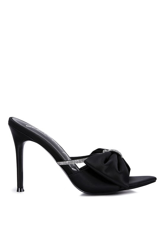Side view of black satin bow stiletto mule with rhinestone strap