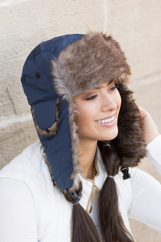 Navy faux fur aviator style winter hat with plush lining, angled profile