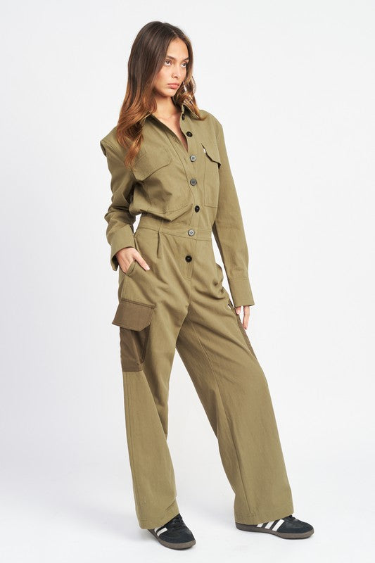 Side view of model wearing military-inspired olive jumpsuit with wide-leg silhouette.
