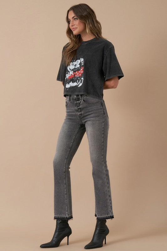 Model wearing high-rise grey bootcut jeans and black ankle boots – side view