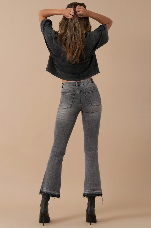 Back view of grey denim jeans with subtle fading and classic pockets