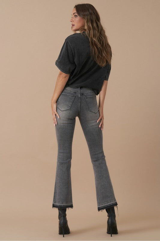 Back view of grey denim jeans with subtle fading and classic pockets