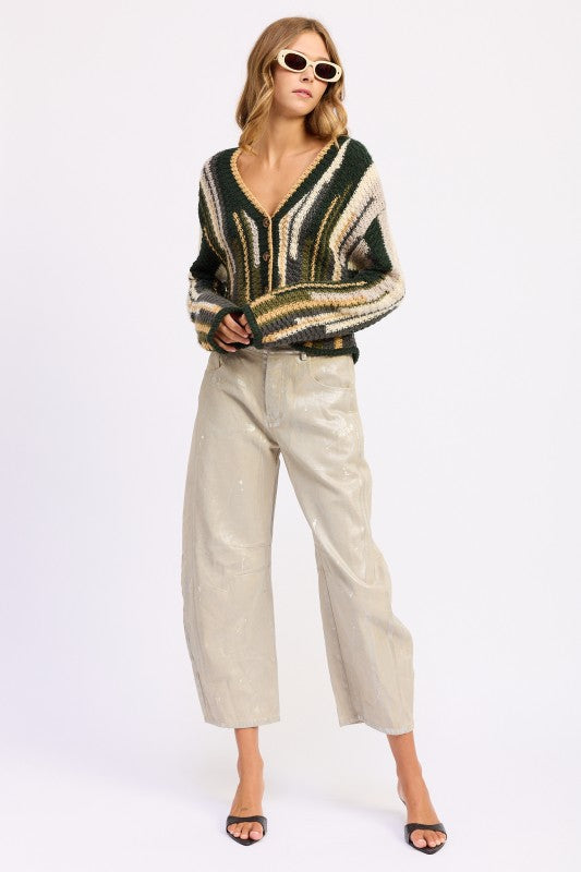 Full outfit view of olive striped cardigan styled with light pants and black heels