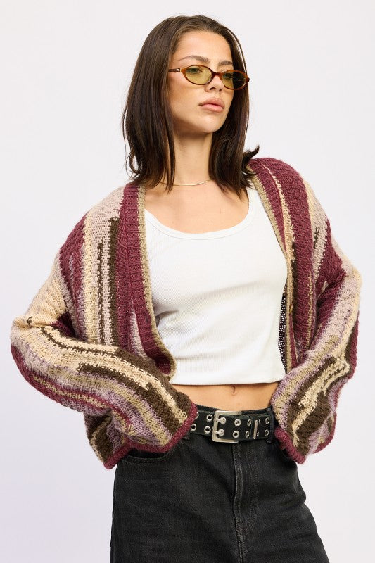 Model wearing burgundy striped open-knit cardigan with white tank and black jeans -AVAH
