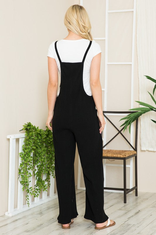 Back view of black ribbed cotton jumpsuit with relaxed straps