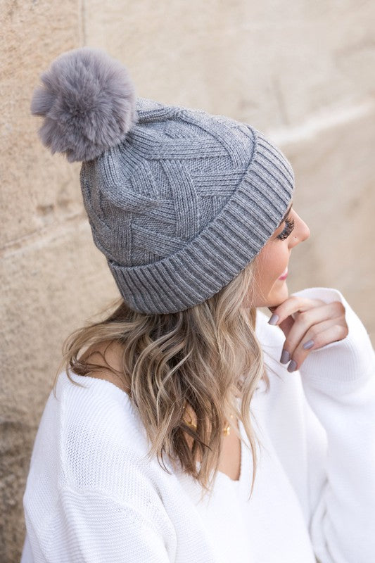 Grey textured knit pom winter hat, side angle