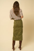 Back view of olive denim midi skirt with large back pockets.