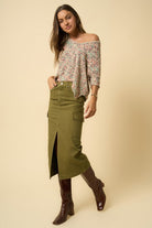Side angle of olive cargo midi skirt featuring front slit detail.