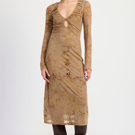 A model wearing a long sleeve midi dress in a mocha color with semi-sheer sleeves and a v-neckline.
