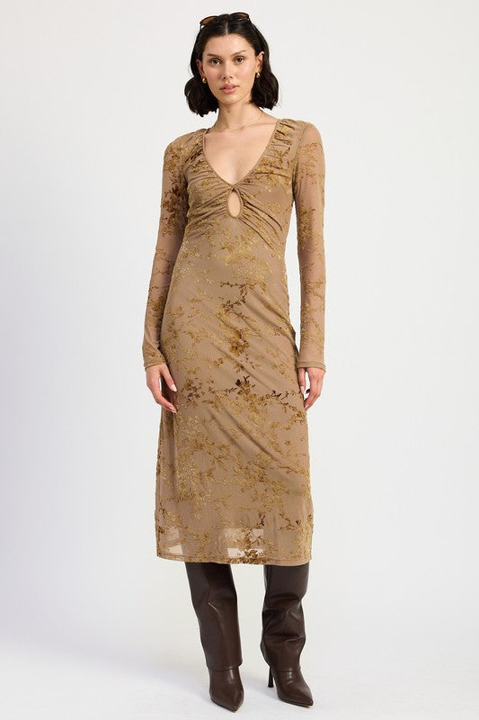 A model wearing a long sleeve midi dress in a mocha color with semi-sheer sleeves and a v-neckline.