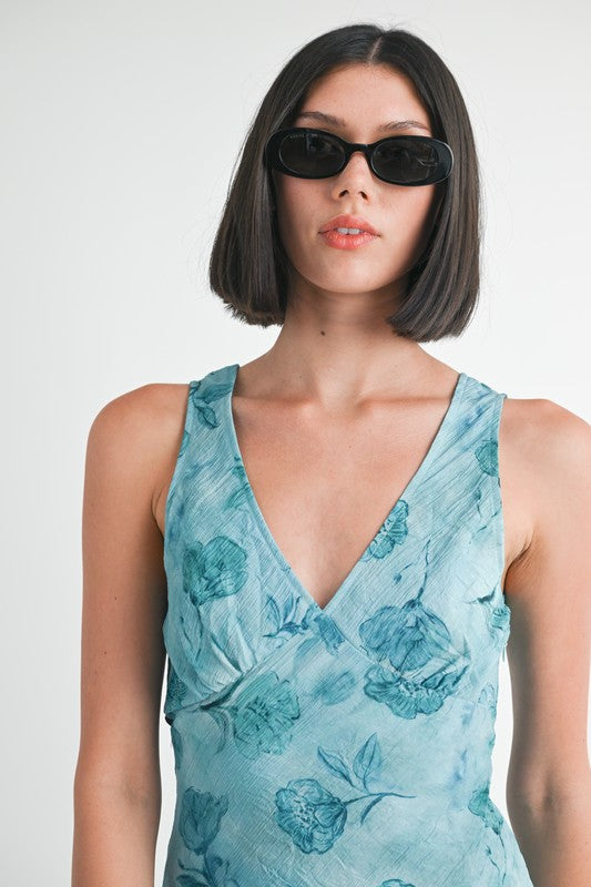 Close-up of V-neckline and blue floral print on textured fabric