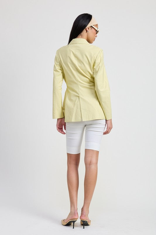 Back view of sage belted blazer with tailored seams and classic blazer structure