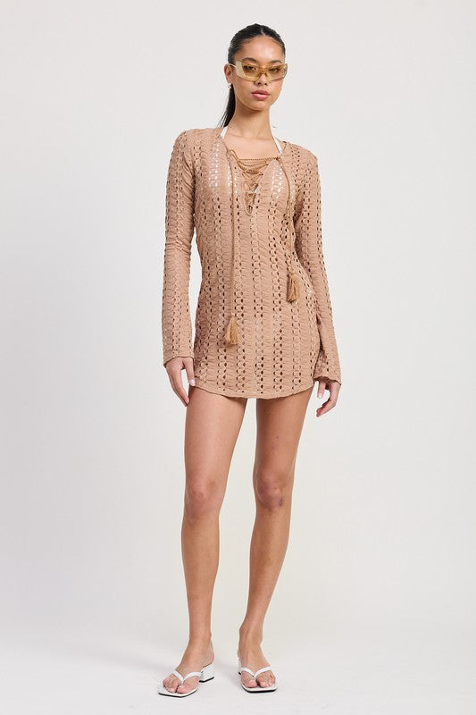 Full body front view of tan crochet mini cover-up styled with white sandals and sunglasses