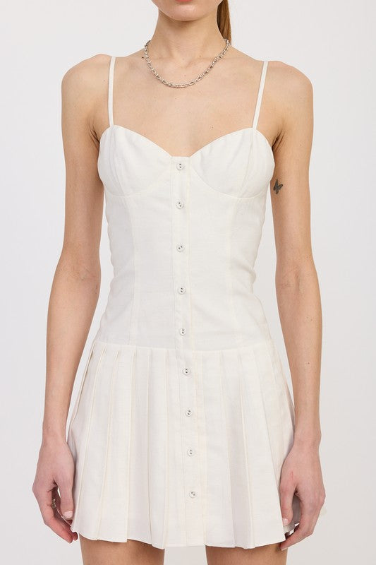 Close-up of bust and bodice of white mini dress with stitched cups and vertical seams