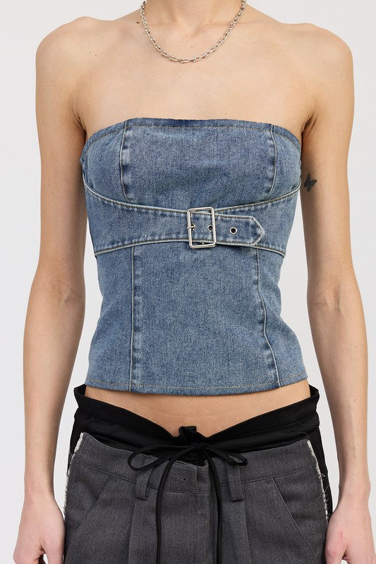 Close-up of medium wash strapless denim top with seaming and silver buckle waist detail
