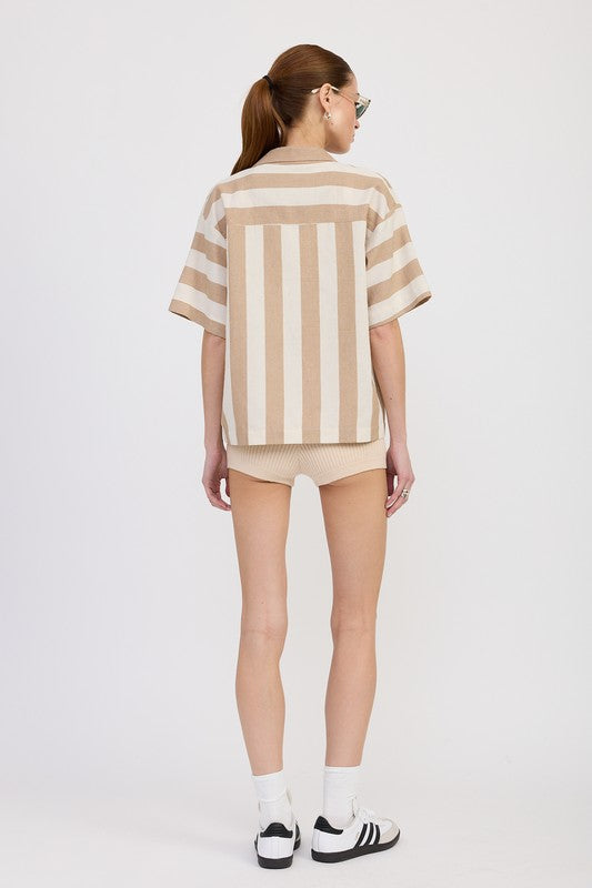 Back view of model wearing mocha striped oversized button-up shirt showing horizontal stripes on sleeves and vertical stripes on back panel