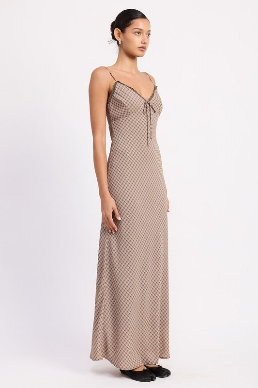 Side view of fitted lattice print maxi dress with flowing hem