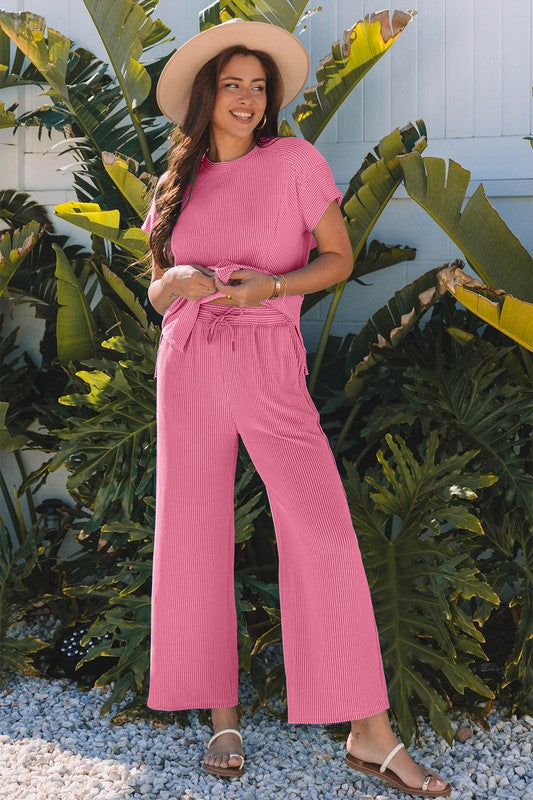 Pink corded set top and pants styled with casual flat sandals.