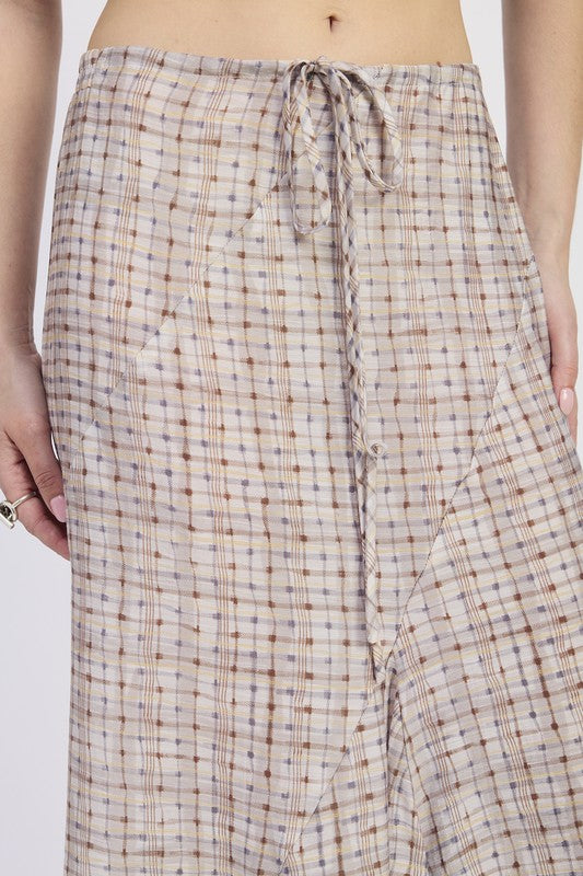Close-up of drawstring waist and plaid pattern on maxi skirt