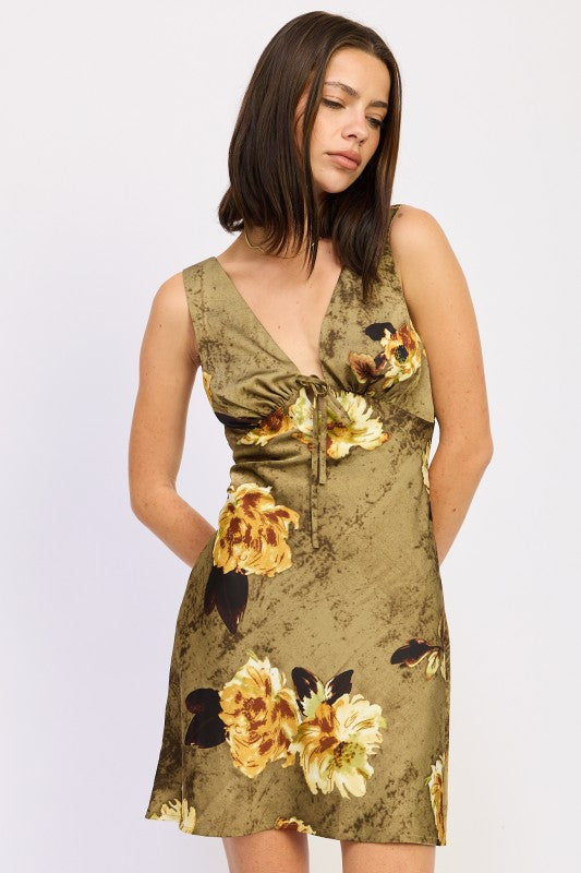 Model wearing olive floral tie-front mini dress with V-neckline, front view