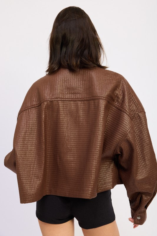 Back view of AVAH brown cropped jacket featuring oversized fit, drop shoulders, and embossed grid texture.