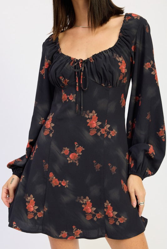close-up of ruched bust and tie detail on black floral dress