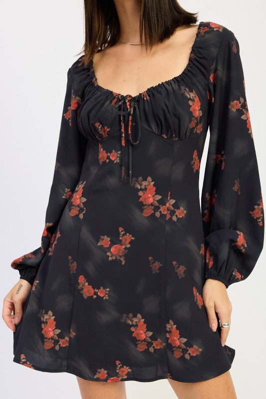 close-up of ruched bust and tie detail on black floral dress