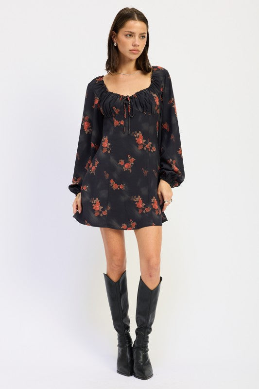 full front view of black mini dress with long sleeves and red floral print