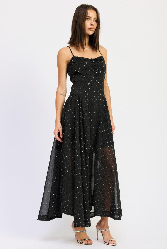 Model in black dotted spaghetti strap maxi dress with ruched neckline, showcasing breezy silhouette and flared hem-AVAH