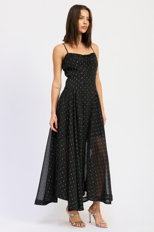 Model in black dotted spaghetti strap maxi dress with ruched neckline, showcasing breezy silhouette and flared hem-AVAH