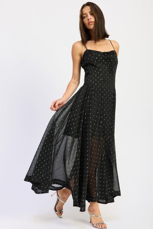 Black maxi dress with dotted detail, flared skirt in mid-movement for an airy, romantic look-AVAH