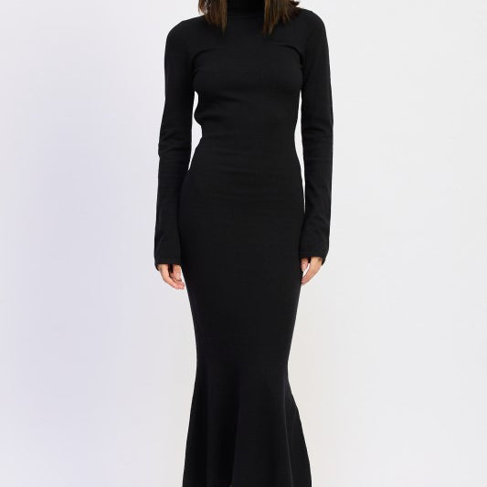 Model wearing the Sienna Whisper Open-Back Knit Dress in black, long sleeves, turtleneck, and mermaid hem.