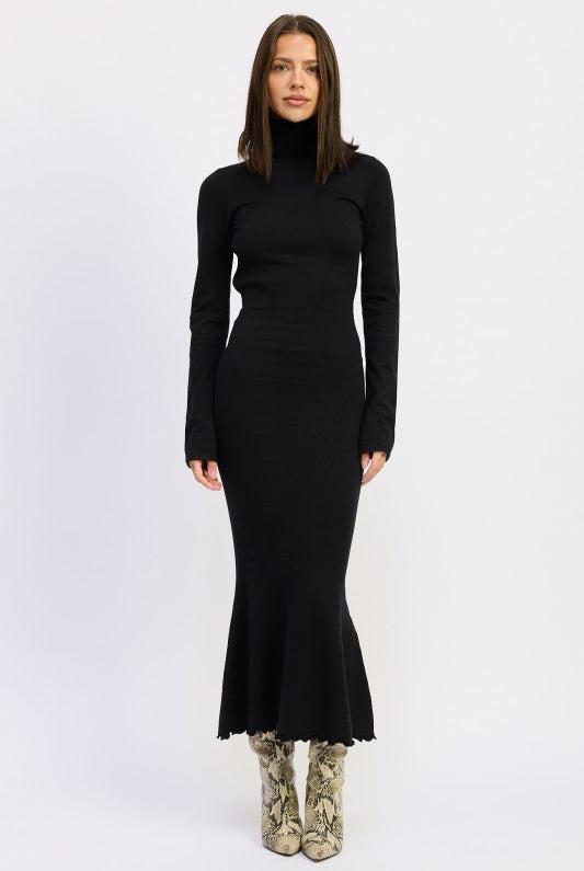 Model wearing the Sienna Whisper Open-Back Knit Dress in black, long sleeves, turtleneck, and mermaid hem.