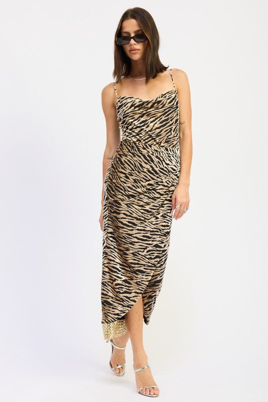 Model wearing a zebra print midi dress on a white background