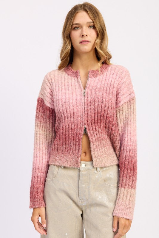Model wearing blush ombre ribbed zip-up sweater