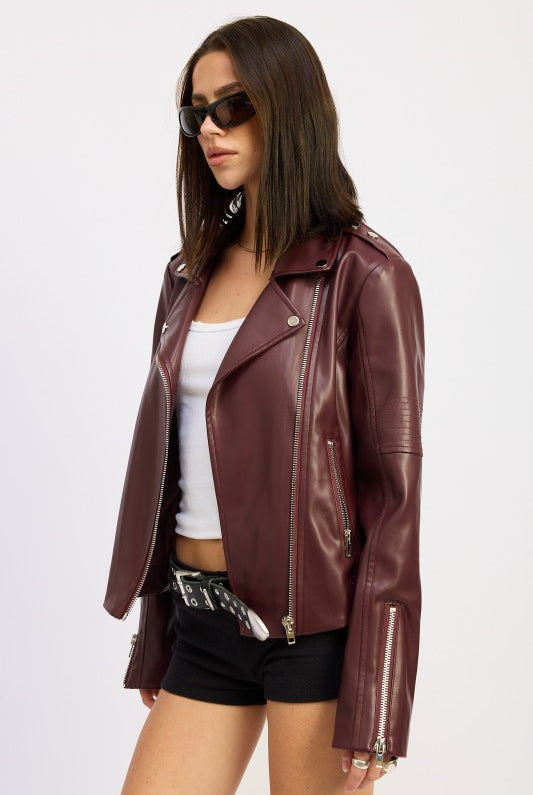 Side pose showing asymmetric zipper and moto collar.