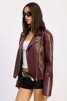 Side pose showing asymmetric zipper and moto collar.