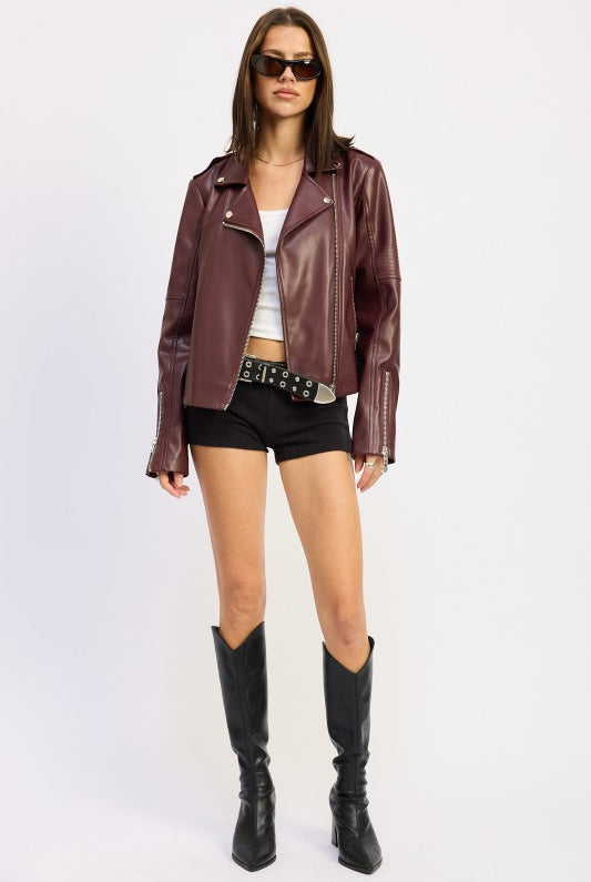 Full-length view of model in burgundy moto jacket with black boots.