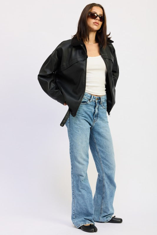 Side angle of black vegan leather bomber jacket with relaxed fit and sherpa collar.