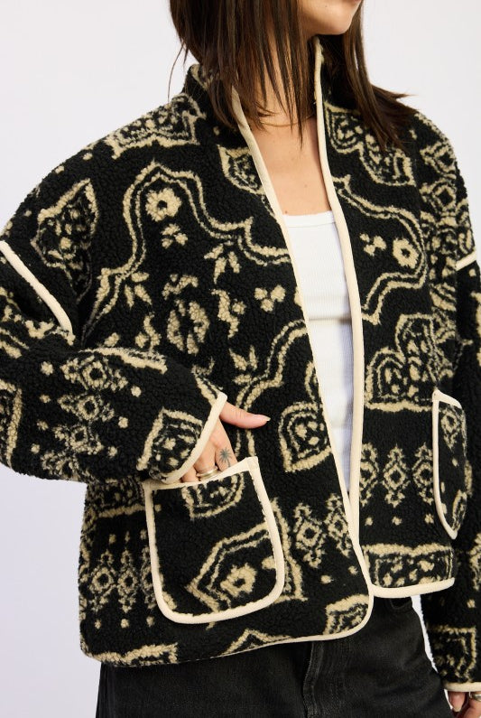 Close-up of sherpa texture and contrast-trim front pockets.